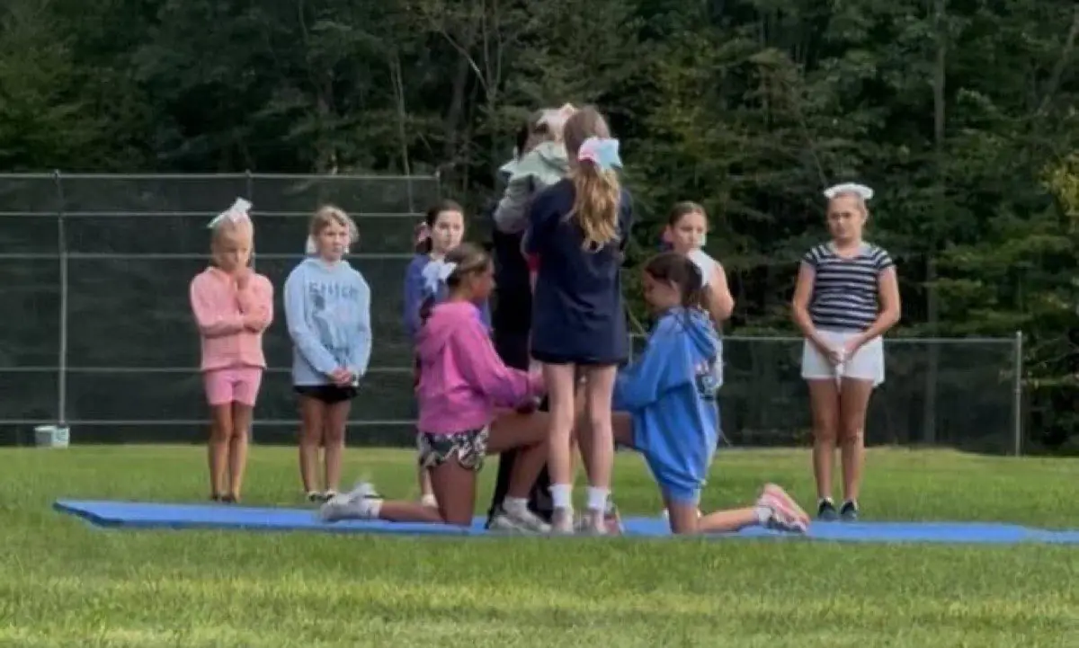 Seahawks cheer team practicing a stunt on mats